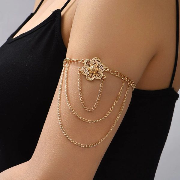 Bracelet bras dorés avec fleur et chaînes pendantes