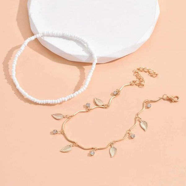 Bracelet de cheville fines chaînes dorés pendentifs feuilles et perles