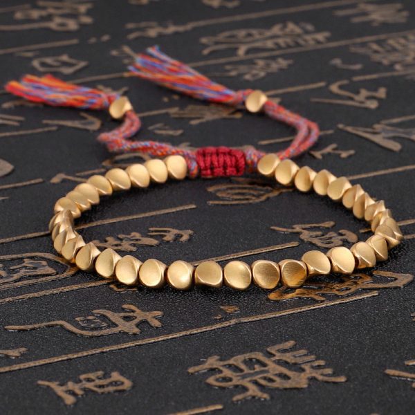 Bracelet bouddhiste tibétain, perles de cuivre et corde tressée